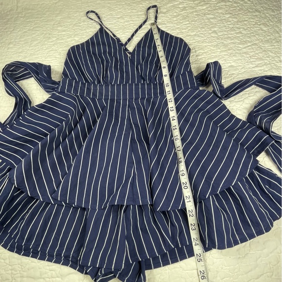 🔥Lulus Ruffle & Flow Black Striped Backless Ruffle
Romper Blue White - Picture 14 of 16